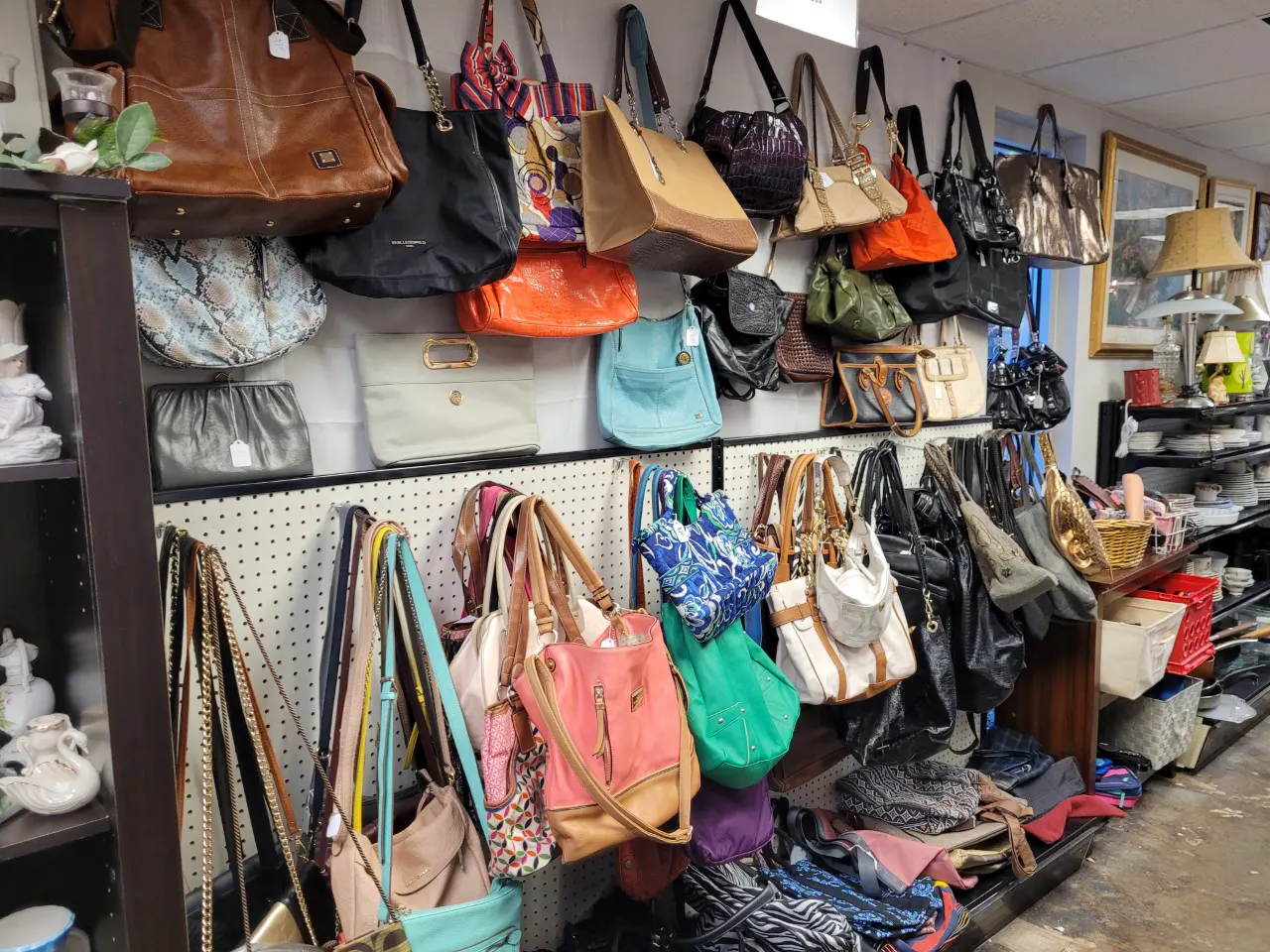Purses hanging in thrift store