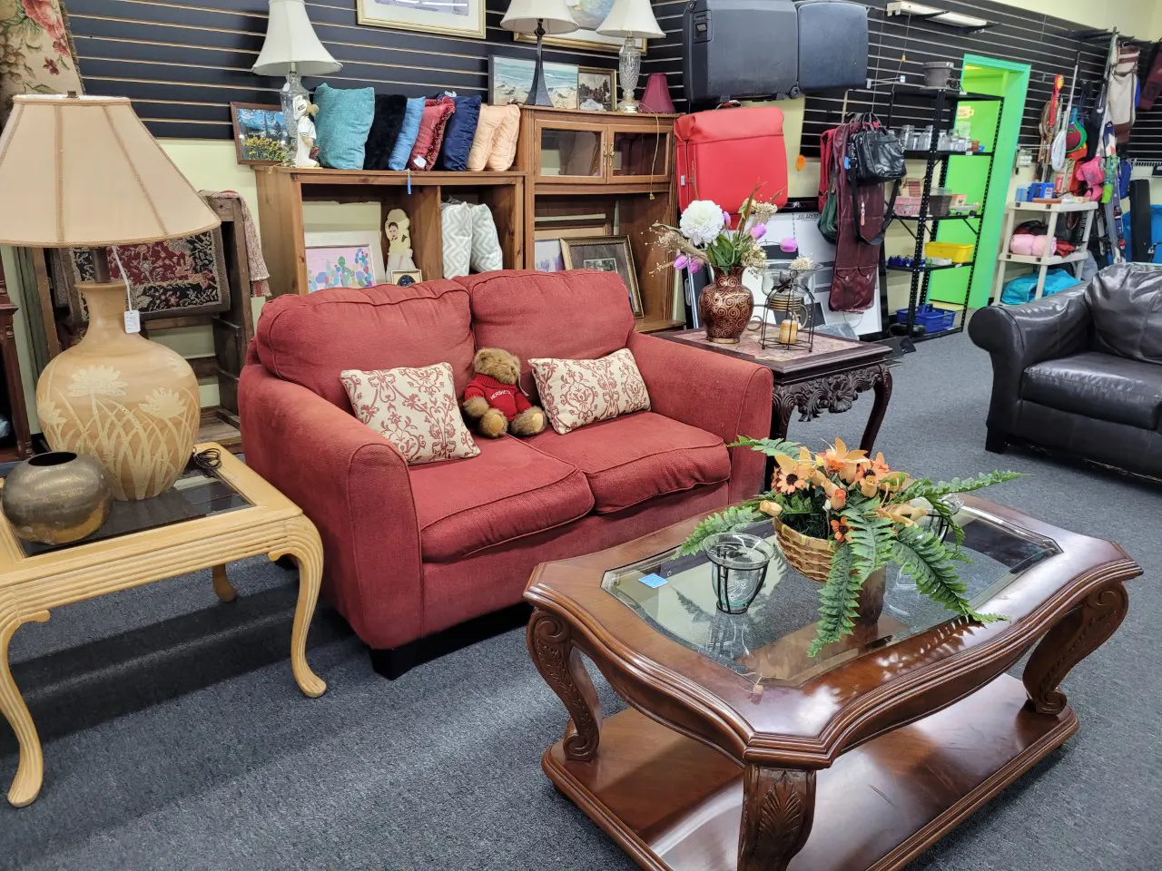 Red couch and coffee table inside thrift store