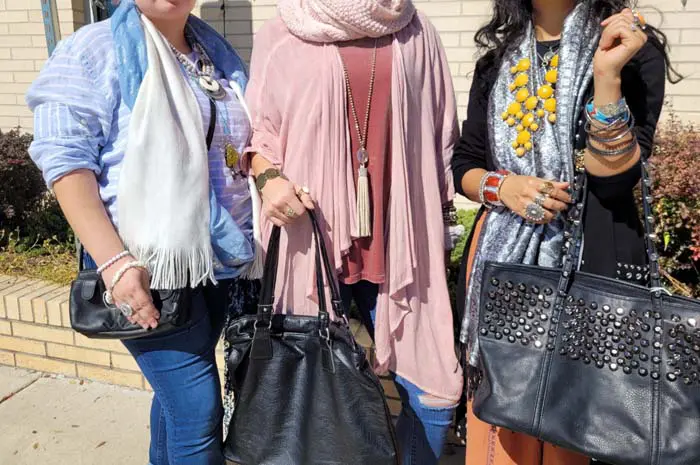 Three women holding purses