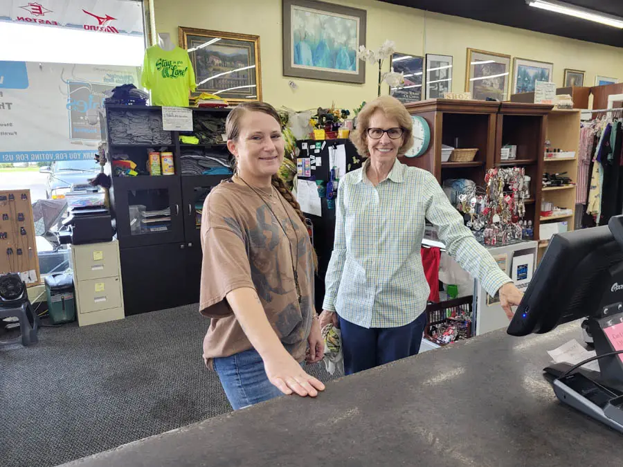 Two ladies behind register at thrift store