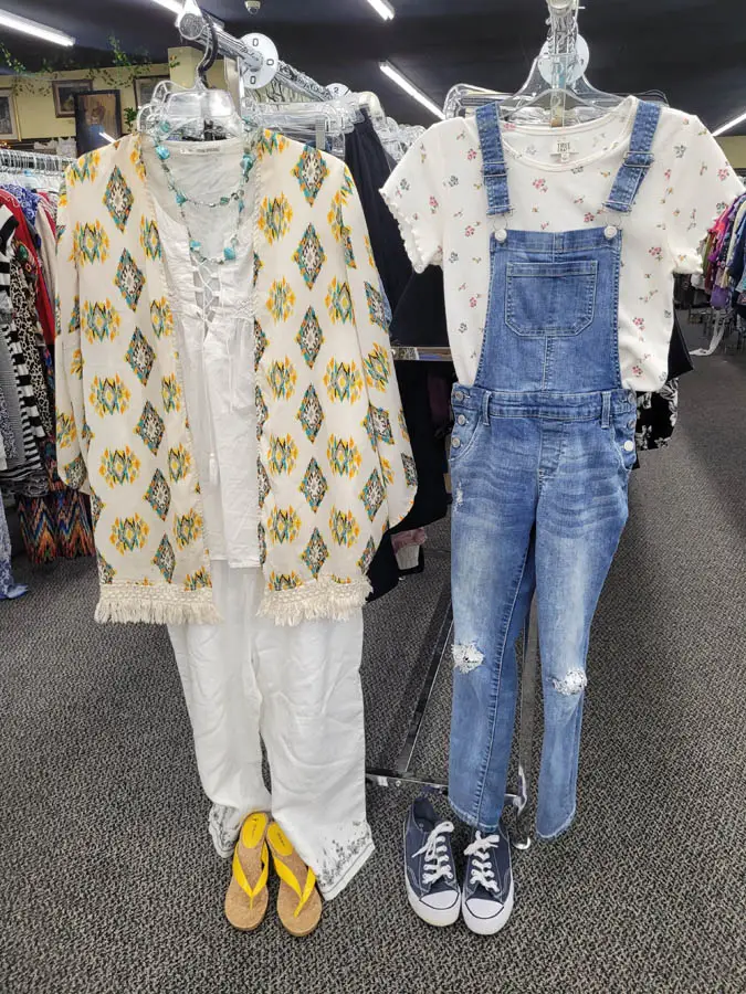 Overall outfit hanging next to button up shirt outfit