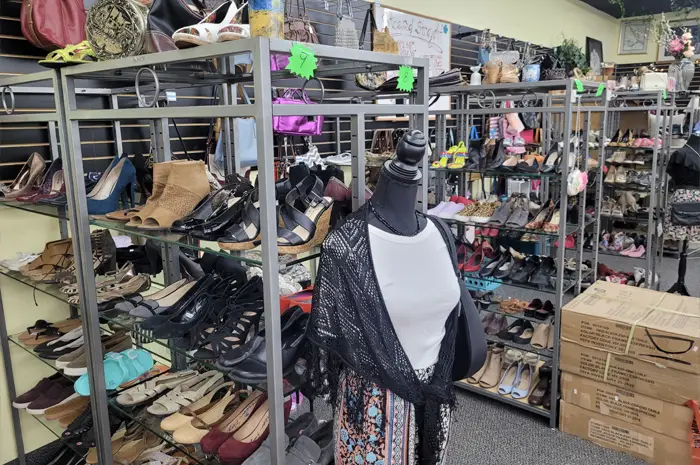 Different items like shoes and clothes on wracks and shelves