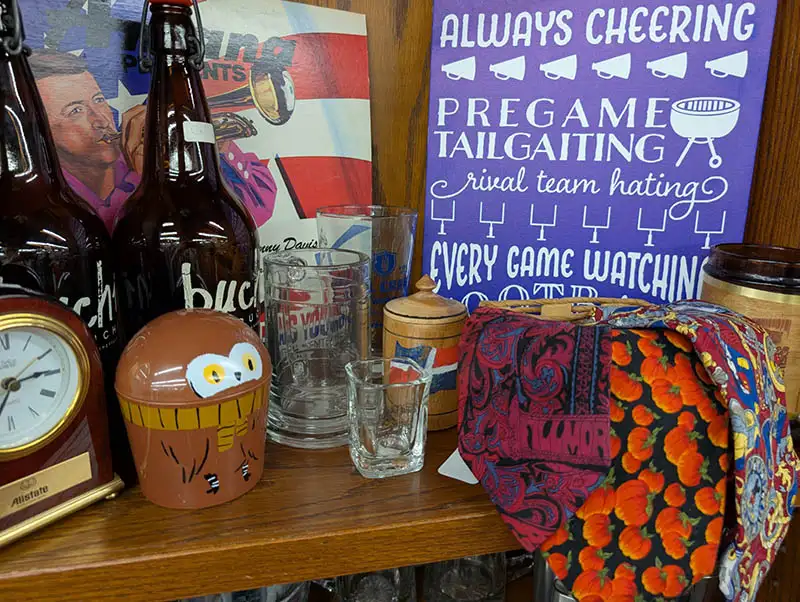 Ties, glasses, and decor on a shelf