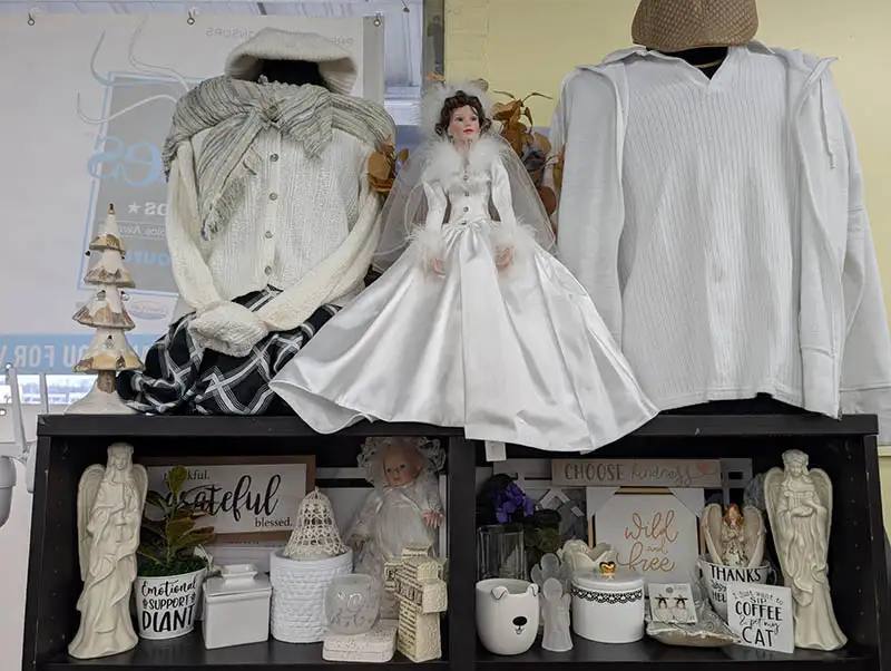 Collection of white thrift items with vintage wedding doll in center