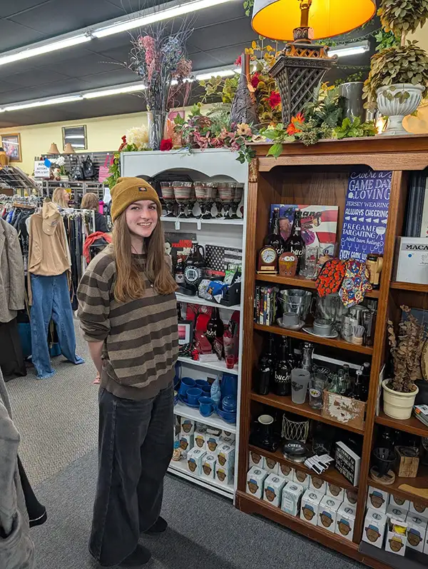 Person standing next to assorted gifts in thrift store