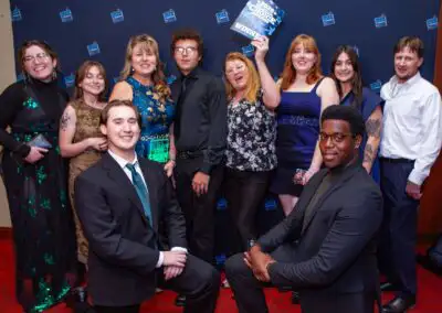 Large group of young people in formal wear posing for a picture