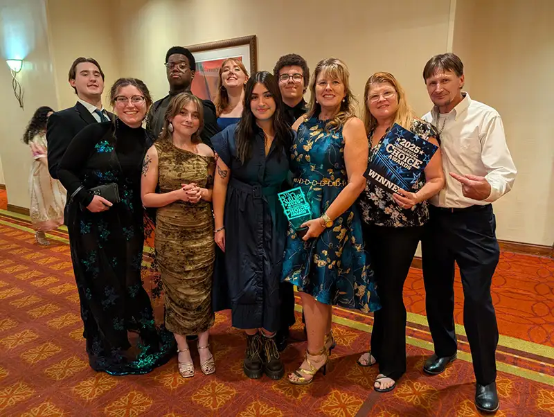 People in formal wear posing for group picture